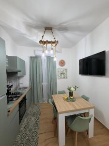 a kitchen and dining room with a table and chairs at Casa Arco Varano in Crotone +23 photos