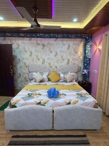 a bedroom with a large bed in a room at Dev Murti Eco Resort in Chālsa Mahābāri