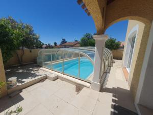 a view of a swimming pool from the patio of a house at Chez DavSon in Cers