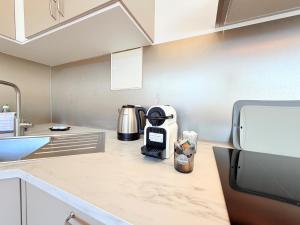 a kitchen with a coffee maker on a counter at Amaroo - Serviced Apartments "Branden" in Potsdam
