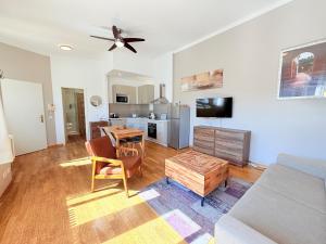 a living room with a couch and a table at Amaroo - Serviced Apartments "Branden" in Potsdam