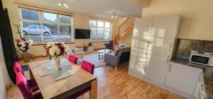 a kitchen and living room with a table and a refrigerator at 12A-1 Stobhill Road in Arniston