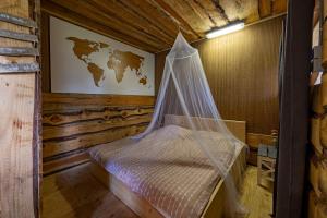 a bedroom with a bed with a mosquito net at Back to Basic in Zwaanshoek