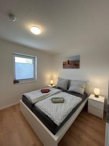 a bedroom with a bed with two lamps and a window at Seebrise in Geeste