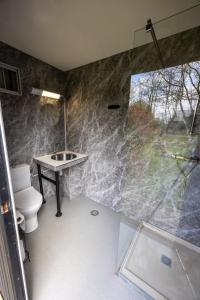 a bathroom with a sink and a toilet and a shower at Back to Basic in Zwaanshoek +44 photos