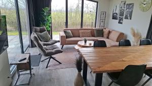 a living room with a couch and a table at Torenvalk 32 in Hulshorst