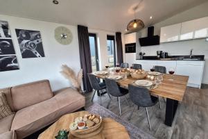 a living room with a table and a couch at Torenvalk 32 in Hulshorst