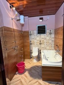 a bathroom with a shower and a toilet and a sink at Dev Murti Eco Resort in Chālsa Mahābāri