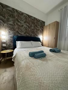 a bedroom with a large bed with two pillows on it at Casa Arco Varano in Crotone