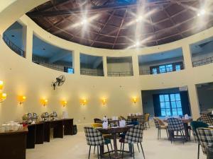 a dining room with tables and chairs and a ceiling at Sukoon Resorts Skardu in Skardu