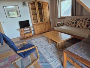 a living room with a couch and a table at Singer-Hof in Krumpendorf am Wörthersee