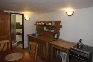 a kitchen with a wooden table and a counter top at Jurta Les Park in Vřesovice +15 photos