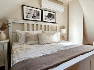 a bedroom with a large bed with two pictures on the wall at Pond View Cabin in Būda