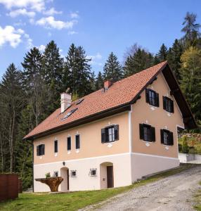 a large white house with a red roof at Die Hube in Leutschach