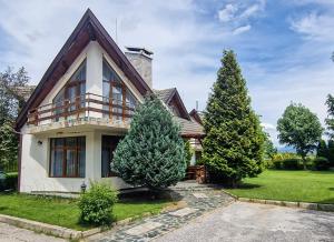 a house with trees in front of it at Villa Deja Vu Private Jacuzzi & Sauna, Fireplace, 3 Bedrooms, near Bansko in Razlog