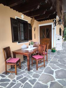 a wooden table and chairs on a patio at Die Hube in Leutschach +29 photos