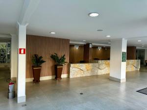 a lobby of a building with potted plants at AP532 Thermas Paradise Cobertura Duplex 2 quartos in Rio Quente +29 photos