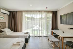 a hotel room with two beds and a desk at Sea lounge in Varna City