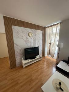 a living room with a flat screen tv on a wall at Cozy Ground Floor Apartment Near U6 Easy Access to Center in Vienna