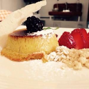 a piece of cake and strawberries on a white plate at Wellness Casa Doña Juana in Tepoztlán