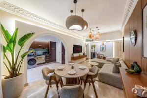 a living room with a couch and a table at Luxury Apartment with Private Jacuzzi & Pool Central Marrakech in Marrakesh