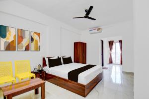 a bedroom with a bed and a ceiling fan at Super Hotel O Destiny Inn in Pune