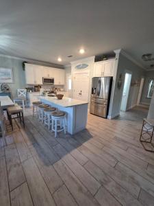 a kitchen with a white island and a counter top at Pelican's Perch in Santa Rosa Beach