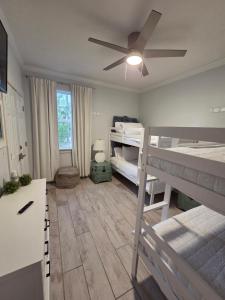 a bedroom with two bunk beds and a ceiling fan at Pelican's Perch in Santa Rosa Beach
