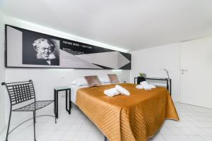 a bedroom with a bed and a tv on the wall at Muta House in Sorrento