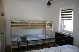 two bunk beds in a room with a window at Mountain View Mojstrana in Mojstrana