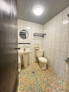 a bathroom with a toilet and a sink at 綠島-Hi Young 漾&漾居 in Green Island