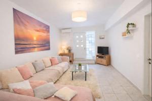 a living room with a couch and a tv at Yviome Rhodes Central Escape in Rhodes Town