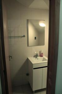 a bathroom with a sink and a shower with a mirror at Flat Mimmo in Praia