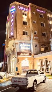 a white truck parked in front of a building at Al Deyafah Narjis-الضيافة نرجس in Khamis Mushayt