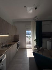 a kitchen with a view of a table and a view of the ocean at Ammos in Kavála