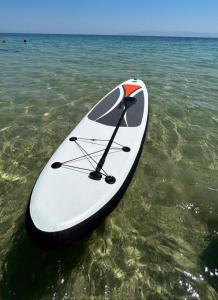 a paddle board is sitting in the water at Ammos in Kavála