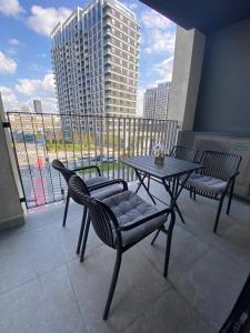 a balcony with a table and chairs and a view of a building at Aria Lux Belgrade Waterfront in Belgrade