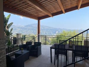 a patio with a table and chairs on a balcony at French Riviera near Nice Monaco, Apartments in Villa, Sea Montain View in Carros