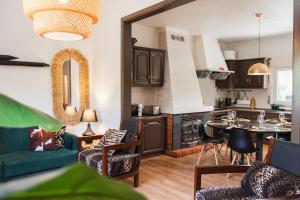 a kitchen and living room with a table and chairs at Chitaka's Organic Farmhouse in Ribatejo in Santo Estêvão
