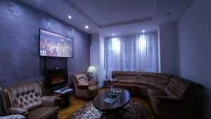 a living room with a couch and a fireplace at Vila Rapsodia Sinaia in Sinaia