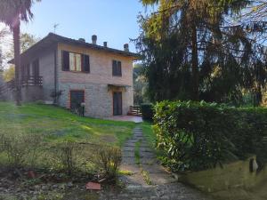 a house on a hill with a pathway leading to it at Il Boschetto in Le Grazie
