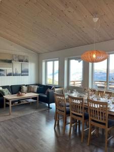 a living room with a table and a couch at Affordable Luxury Sauna Chalet - River Views in Vossevangen