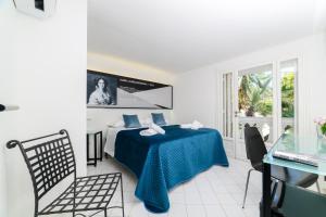 a bedroom with a bed and a table and chairs at Muta House in Sorrento