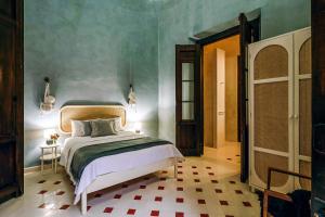a bedroom with a bed in a room at CASA EEB - 4BR Home Colonial Elegance Downtown Merida in Mérida +37 photos