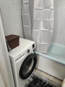a washer and dryer in a small bathroom at 2 кімнатні апартаменти в центрі міста in Pavlohrad +2 photos