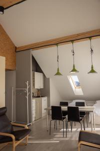 a kitchen and dining room with a table and chairs at Apartamenty Doliny in Szczyrk