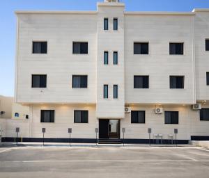 a white building with black windows at الشقق الفاخرة luxury aparments in Medina