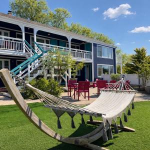 a hammock in a yard in front of a house at The Foxberry - A Digital Concierge Guesthouse in Provincetown