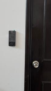 a door with a remote control on the side of it at Suite Privada Moderna in Santa Ana Chiautempan +2 photos