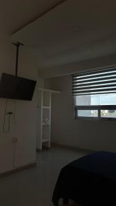 a bedroom with a bed and a large window at Suite Privada Moderna in Santa Ana Chiautempan